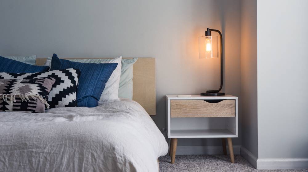 black table lamp on nightstand matress sizes unsplash featured image