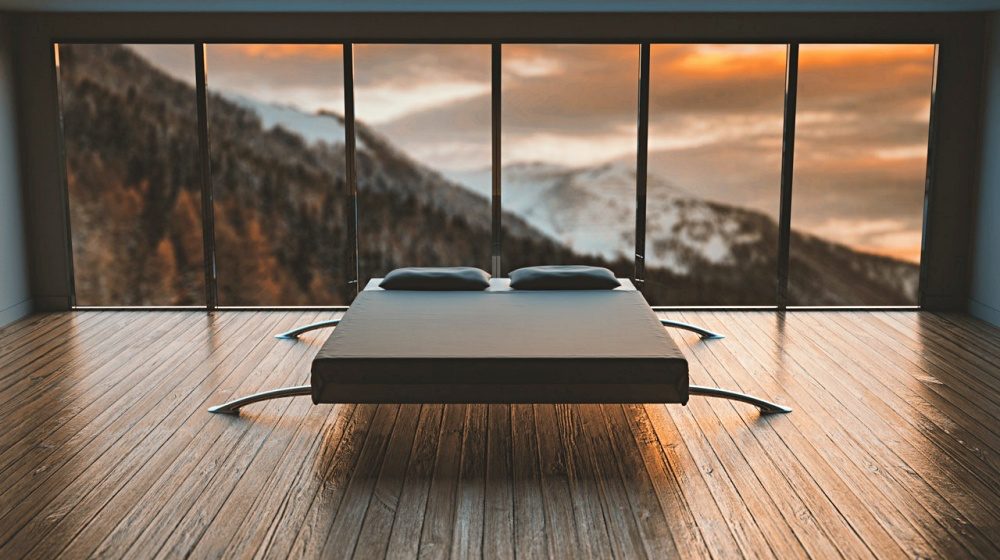 black mattress in front of a large window behind a mountain | What Are The Qualities Of The Best Firm Mattress | Featured