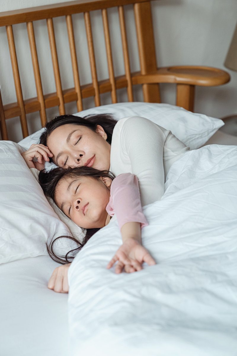 photo of woman and girl lying on bed | impact of sleep on mental health