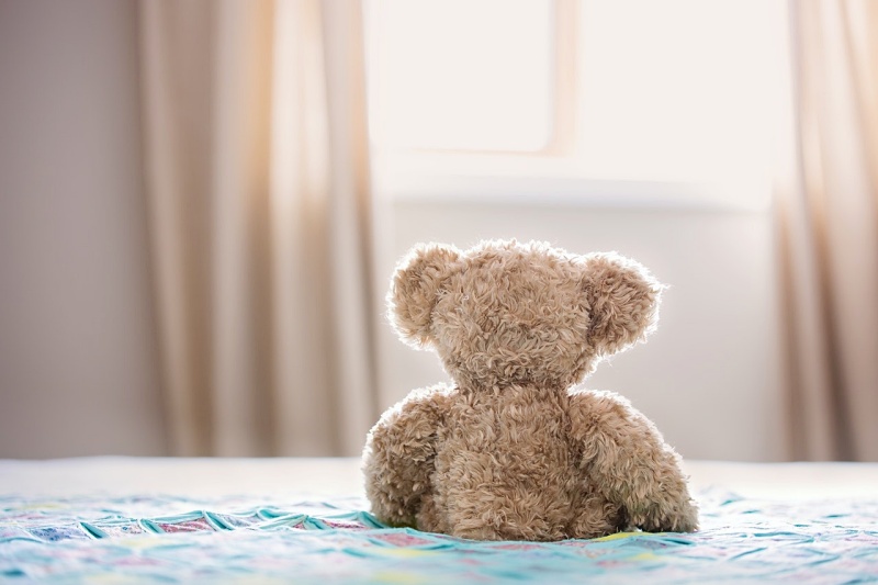 brown bear plush toy on bed | mattress spring