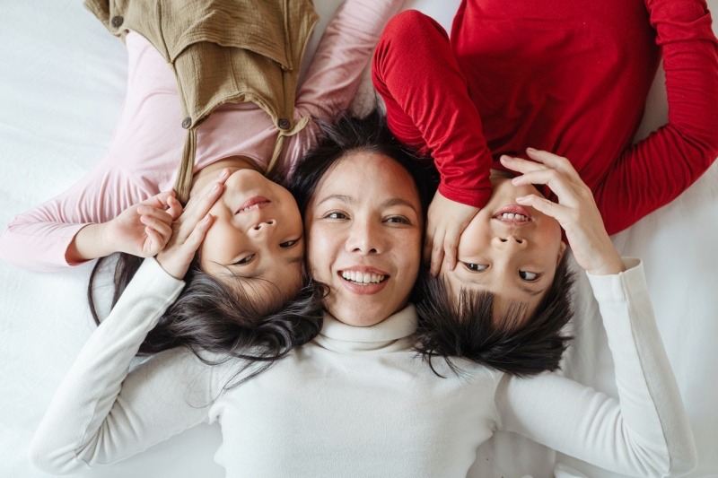 photo of woman and her children lying on bed | ipedic collection