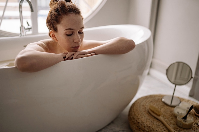 a woman sitting on bathtub | stress relief tools
