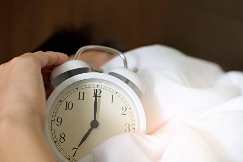 photo of person holding alarm clock | sleeping tips