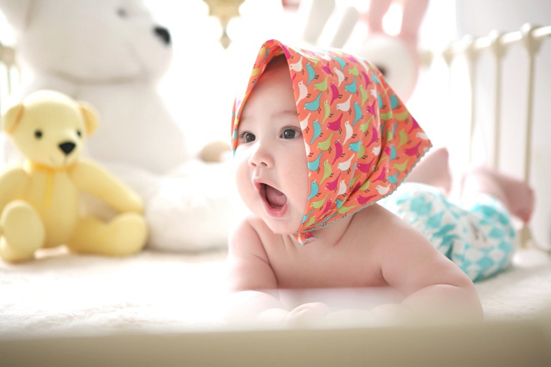 toddler wearing head scarf in bed | baby's sleep pattern
