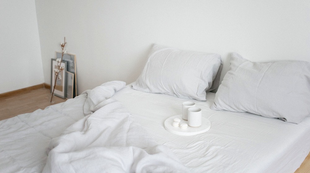 white cups on the bed | Pros And Cons Of Putting Your Mattress On The Floor Without A Frame | Featured