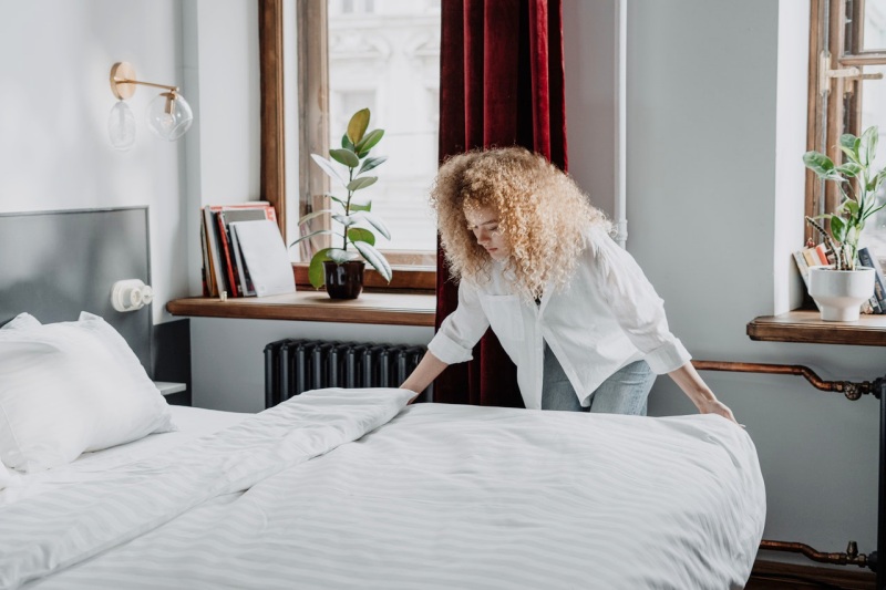 woman in white long sleeve shirt sitting on bed | memory foam mattress