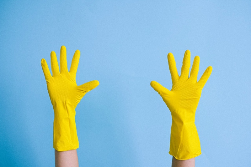 crop unrecognizable person in rubber gloves raising arms | warning