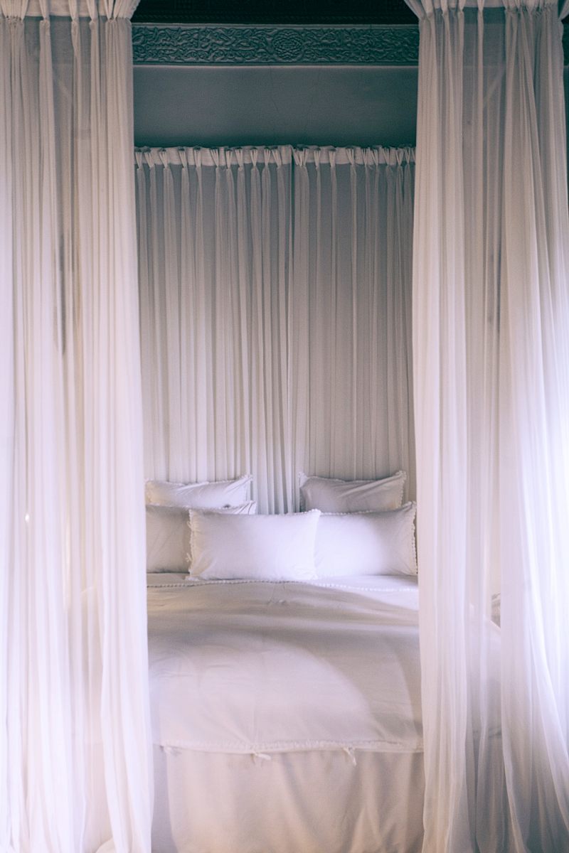 cozy bed under white translucent canopy | thread count