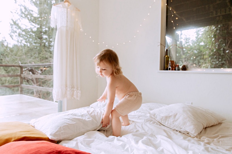 photo of child holding pillows | polyester