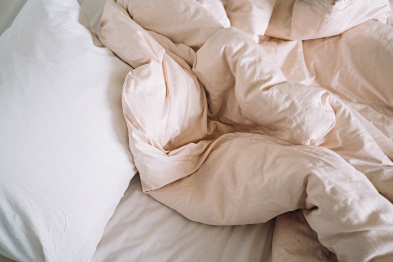 a comforter on a bed | do pillows expire