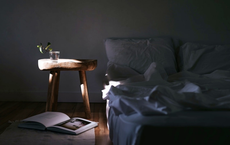 bed and an open book on the floor | melatonin