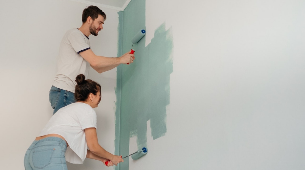 couple painting a wall | Relaxing Bedroom Color Ideas For A Good Night's Sleep | Featured