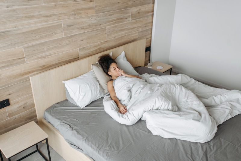 sick woman on the bed | antiviral mattress protector