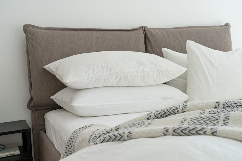 white pillows on a bed | should shoulders be on pillow when sleeping