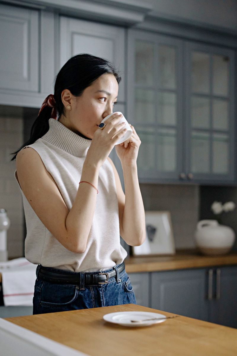 woman in sleeveless shirt drinking from a cup | sleep aid