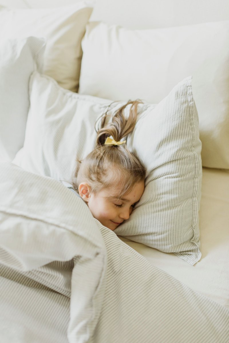 photo of a girl sleeping on bed | science of sleep