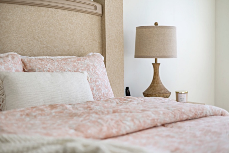 lamp by hotel room bed | mattress for seniors